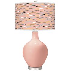 a pink table lamp with a beige shade on it and a white base underneath the light