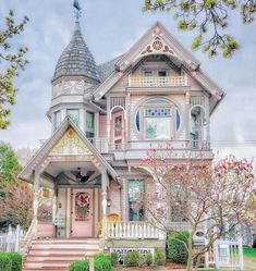 a pink house with a white picket fence