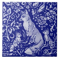 a blue and white tile with an image of a fox and two cubs on it