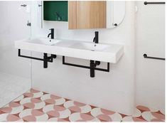 a bathroom with two sinks and a mirror on the wall next to a tiled floor