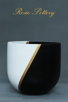 a black and white bowl sitting on top of a table