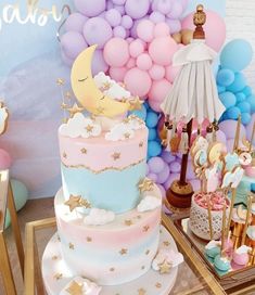 there is a cake on the table with balloons in the background and decorations around it