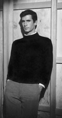 a black and white photo of a man in a sweater