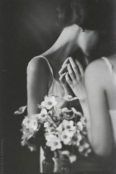 black and white photograph of woman with flowers