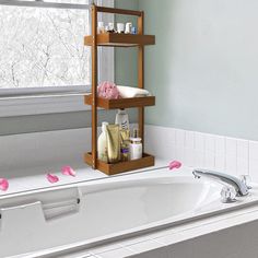 a bathroom with a bathtub and window in the background, it appears to be decorated with pink flowers