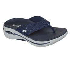 Add some sparkle to your day with Skechers GO WALK Arch Fit Sandal - Dazzle. This sporty thong sandal features a soft fabric upper with rhinestone detail, lightweight ULTRA GO cushioning, high-rebound Comfort Pillar technology, and a contoured Goga Mat footbed with podiatrist-certified Arch Fit support. | Skechers Women's GO WALK Arch Fit - Dazzle Sandals | Medium Width Skechers Go Walk, Platform Flip Flops, Beach Flip Flops, Wide Shoes, Shoe Boot Sandals, Navy Fashion, Skechers Women, 4 Inch Heels, Designer Sandals