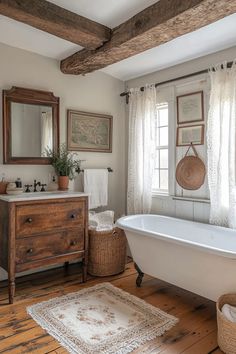 an old fashioned bathtub in a rustic bathroom with white walls and wood flooring