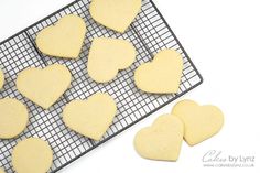 heart shaped cookies on a cooling rack with one cut out and the other uncooked