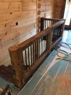 the inside of a wooden cabin with some tools on the floor and wood planks around it