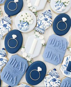 blue and white decorated cookies with the words miss to mrs written on them, surrounded by wedding rings