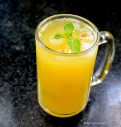 a glass mug filled with lemonade and mint