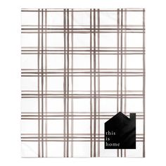 a white and brown plaid pattern with the words this is home in black on it