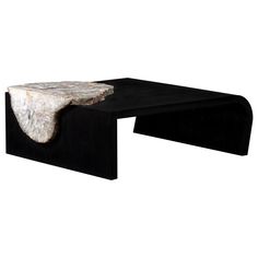 a black and white table with a marble slab at the top, on a white background