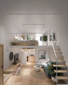 an open concept living room with stairs leading up to the loft