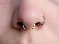 Switch up your daily jewelry with a minimalist but delightfully punk spike septum ring, handmade by shop member Jo with sterling silver.  This listing is for one spiked horseshoe-shaped septum ring. CIRCLE NOSTRIL RING NOT INCLUDED.  This listing includes small silicon rings, pictured in images 2-4, to be slid onto the jewelry and hold it in place while being worn, to prevent sliding and falling out. You will receive 4 total rings, 2 to wear and 2 as extras, in case the others are lost.  Jewelry is 16g, and designed for septum piercings. Not recommended for children. Not a fake septum ring, this jewelry will not be wearable unless you have a pierced septum.  The ends of the ring have been filed to points. They are safe to wear but a bit pointy, so exercise caution when inserting and wearin Horseshoe Septum Piercing, Silicon Rings, Septum Piercing Jewelry, Nostril Ring, Septum Piercings, Daily Jewelry, Jewelry Safe, Silicone Rings, Septum Piercing