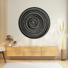 a living room with a large black and white circular wall art hanging on the wall