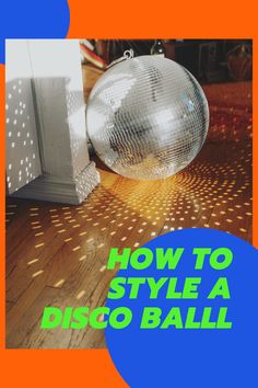 a disco ball sitting on top of a wooden floor with the words how to style a disco ball at the look