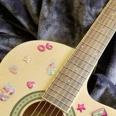 a close up of a guitar with buttons on it