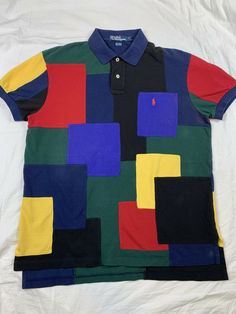 RARE VTG RALPH LAUREN POLO 100% COTTON COLORBLOCK SHORT SLEVE POLO SHIRT PONY LOGO EXCELLENT CONDITION. SOME AREAS OF DISCOLORATION-SEE LAST 3 PICTURES. COLLAR LABEL IS DAMAGED DUE TO DRY CLEANING LABEL BEING PULLED OFF. TAGGED SIZE M MEASUREMENTS LAYING FLAT CHEST- 21 1/2” SHOULDERS-19” LENGTH-28” Multicolor Collared Top With Color Matching, Black Polo Collar Top With Patchwork, Fitted Color Block Polo Shirt, Fitted Multicolor Polo Shirt, Casual Collared T-shirt With Patchwork, Casual Collared Patchwork T-shirt, Short Sleeve Cotton Polo Shirt With Color Block, Short Sleeve Color Block Cotton Polo Shirt, Color Block Cotton Polo Shirt