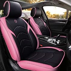 the interior of a car with pink and black seats