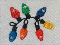 an embroidered t - shirt with christmas lights on the front and back, which are multicolored