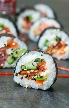 sushi rolls with various toppings on a table