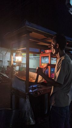 a man standing in front of an oven cooking food