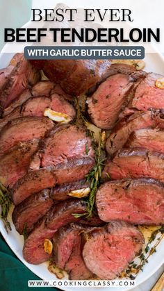 the best ever beef tenderloin with garlic butter sauce on a white platter