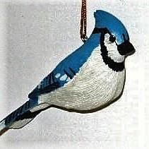 a blue jay bird ornament hanging from a chain