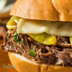 a pulled pork sandwich with cheese and pickles