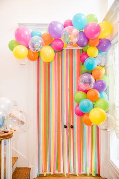 the door is decorated with balloons and streamers