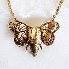 "Gold Elephant With Butterfly Wings Pendant Necklace Handmade Measures 3\" W X 2\" H Hand Cast With Every Detail In Mind" Bohemian Gold Hand Cast Necklace, Hand Cast Brass Necklace For Gift, Hand Cast Brass Necklace Perfect For Gifts, Nickel-free Gold-tone Brass Necklace, Hand Cast Brass Pendant Jewelry, Hand-cast Brass Pendant Jewelry, Hand Cast Gold Brass Necklace, Symbolic Electroformed Gold Jewelry, Gold Hand Cast Brass Necklace