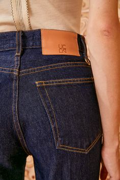 The Agnes Jean is a forever favorite reimagined with a cropped, straight-leg in our deep indigo Tigris wash. Handmade in Los Angeles from premium non-stretch denim, this classic style features a high rise, clean lines, and is traced with contrast stitching. It is finished with a logo-embossed leather patch and hand-hammered ring at the back belt loop. Composition: 100% Cotton Pair with our Halia Earring to complete the look. Nyc Boutiques, Deep Indigo, Hammered Ring, Knit Sweatshirt, Signature Print, Handbag Shoes, Cropped Denim, Leather Patches, Event Dresses