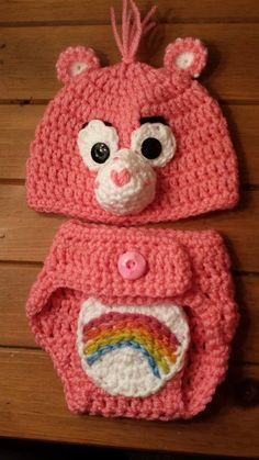 a crocheted bear hat and diaper cover with a rainbow on the front