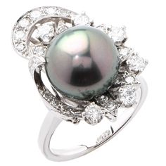 Fine 12mm Tahitian Pearl and Diamond ring. This gorgeous ring features a very fine 12mm Tahitian pearl surrounded by approximately 1.2 carats of mix cut diamonds. Ring Size: 7 (can be sized) Metal Type: 14Kt White Gold (stamped and/or tested) Metal Weight: 10.1 Grams White Gold Pearl Ring, Tahitian Pearl Ring, Pearl Diamond Ring, Stars Align, Gold Pearl Ring, Shine A Light, Vintage Cocktail Ring, Pearl And Diamond Ring, Fine Diamond Jewelry