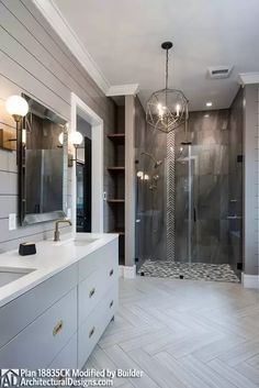 a large bathroom with a walk in shower next to a double sink and two sinks