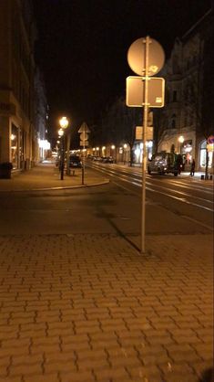 an empty street at night with no cars on it