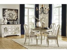 a dining room table with chairs and a chandelier