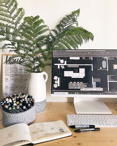 a computer monitor sitting on top of a wooden desk next to a keyboard and mouse