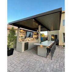 an outdoor kitchen and dining area is shown