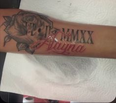 a woman's arm with the word mama written in red and black ink on it