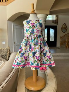 ★*.*'.*★ENCANTO/MIRABEL Baby/Toddler Dress★*.*'.*★ The dress is a sundress style, with extra long straps to make a fancy bow at the back. The back has elastic for a snug fit. The bottom is trimmed with a pink ric rack for an extra fancy style. Available in sizes NB-8yrs Shipping time is currently 1-2 weeks for this dress We do our absolute best to get your dresses shipped faster than that, but we cannot currently promise dresses before the expected ship date. If you need a romper by a certain de Cute A-line Sundress For Garden Party, Spring Cotton Twirl Sundress, Fitted Cotton Sundress For Dress-up, Fitted Cotton Sundress For Dress-up Occasions, Whimsical Summer Playtime Dress, Playful Cotton Twirl Dress For Beach, Playful Cotton Sundress For Garden Party, Cute Cotton A-line Sundress, Cute A-line Cotton Sundress