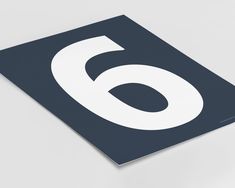 a close up of a number six on a square sticker in blue and white