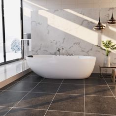 a large white bath tub sitting inside of a bathroom next to a tall glass window