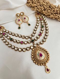 3 layer high quality kundan with meenakari work and faux  ruby and emerald stones . with earrings  Goes with traditional Indian dress , saree   Style tip- ----------- Pair it with any beautiful traditional outfits  and flaunt with Unique style of collection from us. Perfect match for Festival and Traditional wear.  Take Care Tips-  ---------------- Kee away from perfume, Hair spray and. Moisture.  Store in dry place , Ziplock bag or Airtight box.    Clean with dry cloth.  Jewellery is the last t Luxury Meenakari Fusion Jewelry Sets, Luxury Meenakari Necklaces For Diwali, Cheap Temple Jewelry Necklaces For Festivals, Luxury Meenakari Danglers For Formal Events, Luxury Temple Jewelry With Latkans, Luxury Temple Jewelry Sets For Festive Season, Exquisite Jewelry Kameswari Jewellers, Luxury Fusion Kundan Necklace For Rituals, Luxury Heavy Temple Necklace For Navratri