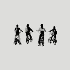 three people are riding bikes in the air