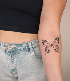 a woman's arm with a butterfly tattoo on the left side of her body