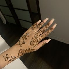 a woman's hand with hendix on it and flowers painted on the palm