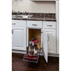 an open cabinet in a kitchen with pots and pans on the bottom shelf, next to a sink