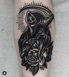 a black and white tattoo on the leg of a person with a skeleton holding a cross